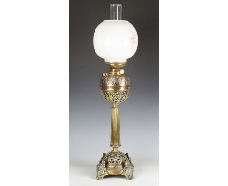 A late 19th century brass table oil lamp with a later opaline glass shade, height 53cm.Buyer’s Premium 29.4% (including VAT @