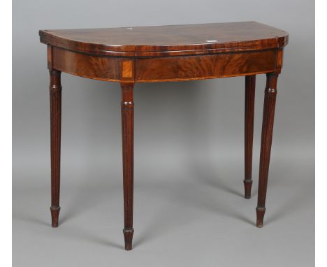 A George III mahogany fold-over card table with satinwood crossbanding and reeded tapering legs, height 73cm, width 91cm, dep