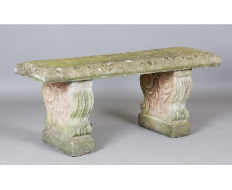 A 20th century cast composition stone garden bench, the rectangular seat on a pair of scrolled supports, height 45cm, width 1