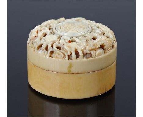 18 Century Chinese pierced carved ivory snuff box with two dragons chasing a pearl, the eyes inlaid with amber. Diameter 4cm 