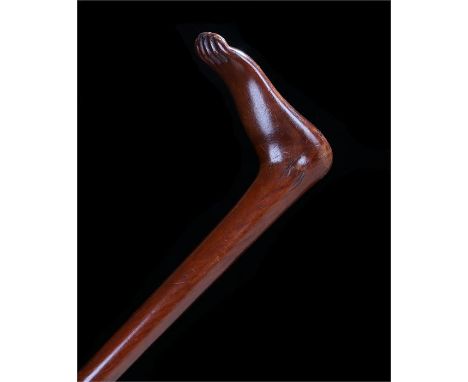 19th Century mahogany walking stick, the handles carved as a bare foot, length 88cm