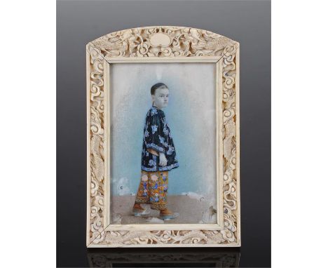 Portrait miniature of a European boy in chinese attire in an easel type ivory frame decorated with dragons and flowers, oil o