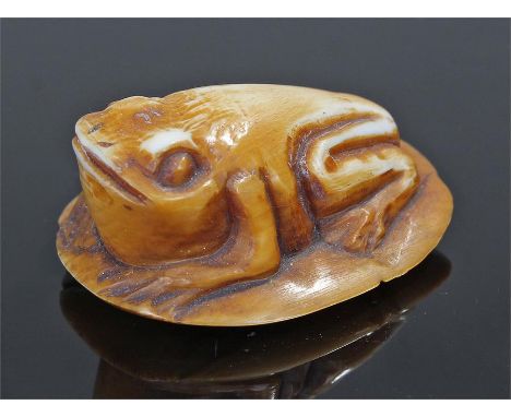 Japanese Meiji period ivory netsuke, in the form of a frog on a lily, signed to the base, 3.5cm long