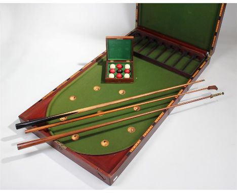 Victorian bagatelle folding table, in mahogany, together with a set of ivory bagatelle balls in the case, also included a bra