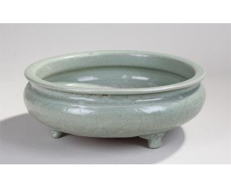 Large Chinese Longquan celadon tripod censer, probably Ming dynasty, thickly potted with a flared rim, short waist and compre