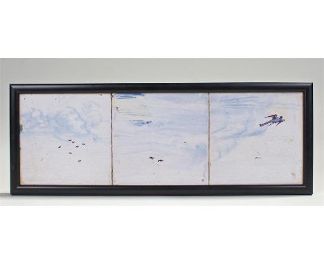 Three pottery tile decorated with birds in the sky and set in a frame, 39cm x 14cm