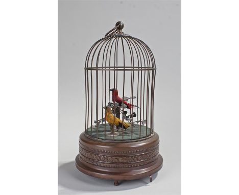 Singing bird musical automaton, the cage above red and yellow birds on branches, the plinth base decorated with flowers, key 