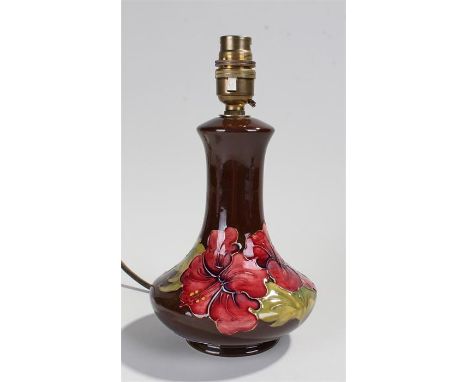 Moorcroft lamp with Hibiscus design decoration the lamp with impressed mark for Moorcroft. Height 18cm