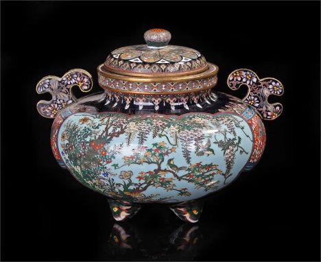 Japanese enamel koro and cover on tripod feet, the squat body with two elaborately decorated panels with birds, trees, wister