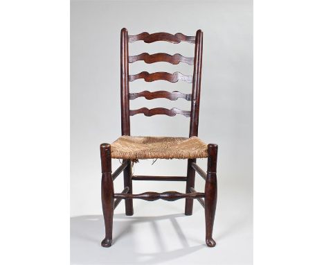 Late 18th/early 19th Century ladder back single chair, the arched ladder back above a rush seat and turned legs