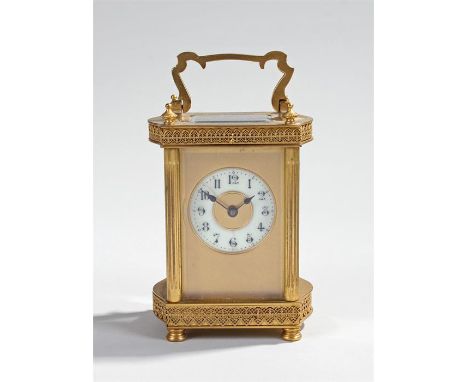 French gilt brass carriage clock, the arched handle with five glass case, fret edging to the top and bottom, cream enamel dia