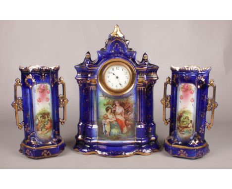 A ceramic three piece clock garniture - decorated in colbalt blue and gilt depicting classical scenes. H: 43cm, W:32cm.  Cond