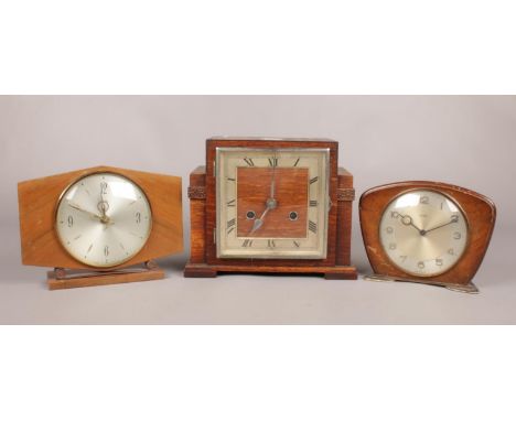 Three wooden mantle clocks - to include an Art Deco Stepped stained Oak clock by Tymo, a Smiths and Metamec examples.  Condit