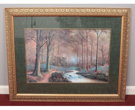 A large framed print of a woodland scene, unsigned. H: 52cm, W: 78cm.  Condition fair. The glass in the frame is cracked.