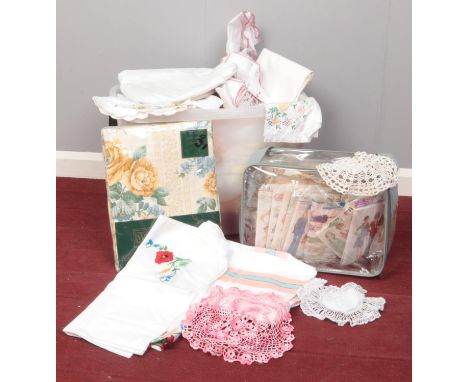 A collection of linens. Tablecloths, curtains, doilies. To include dress making patterns  