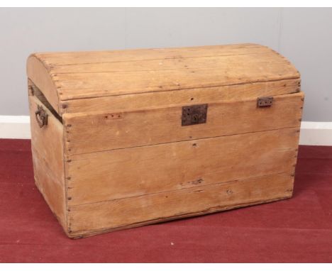 A Pine twin handled dome top chest. (76cm width, 48cm height, 46cm depth)  top of side panel needs repair, chest lid needs re