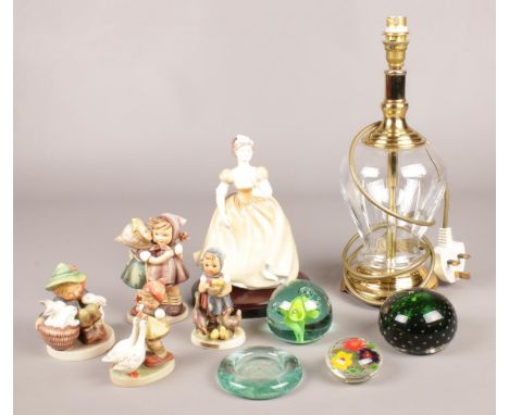 A collection of ceramics and glass. Includes Hummel, glass table lamp, paperweights etc.  