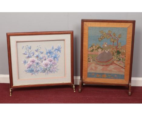 Two decorative fire screens.  Comprising of an Oak framed tapestry of a crinoline lady and a floral ceramic example. Tapestry
