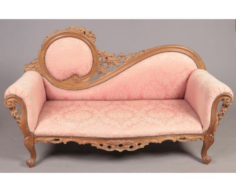 A French style 2 seat parlour sofa with ornate carved wood decoration.  