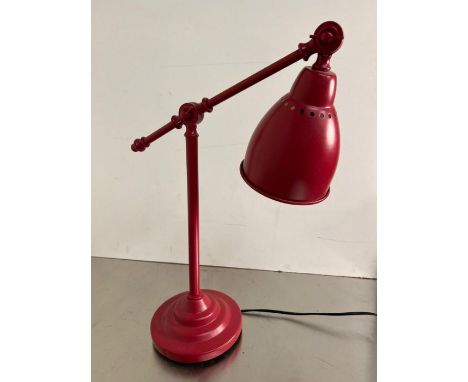 A red Ikea desk lamp