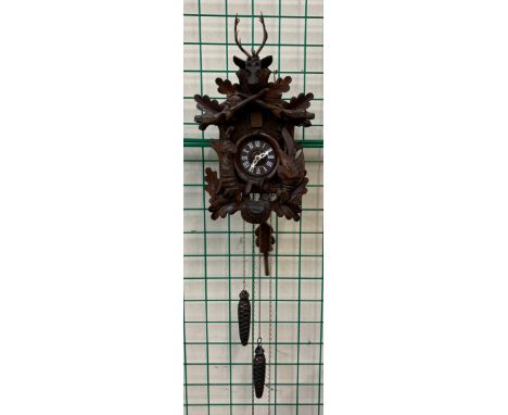 A Black Forest style carved oak cuckoo clock 