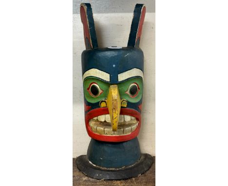 An Aztec style painted grotesque mask 