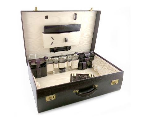 A silver-mounted travelling dressing table set, by Asprey and Co, London 1912, the covers initialled, comprising: a silver-mo