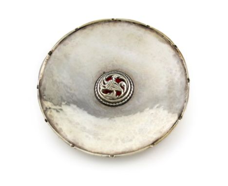 By Omar Ramsden, an Arts and Crafts silver and enamel dish, London 1925, circular form, castellated border, the central with 