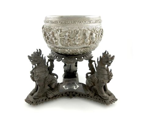 A Burmese silver rice bowl, the underside with the maker's signature of a tiger, circular form, embossed with figural scenes 