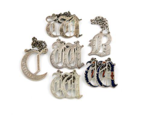 A collection of six Victorian silver 'cut-out letter' wine labels, comprising: one modelled as a 'W', by William Summers, Lon