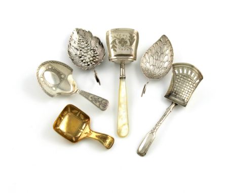 A collection of six antique silver caddy spoons, comprising: a George III one of pierced vine leaf form, embossed with grapes