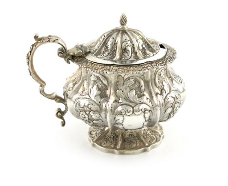 A William IV silver mustard pot, by John E. Terrey, London 1835, lobed circular form, embossed foliate decoration, leaf cappe