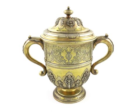 A George I silver-gilt two-handled cup and cover, by Francis Garthorne, London 1724, circular form, leaf capped scroll handle