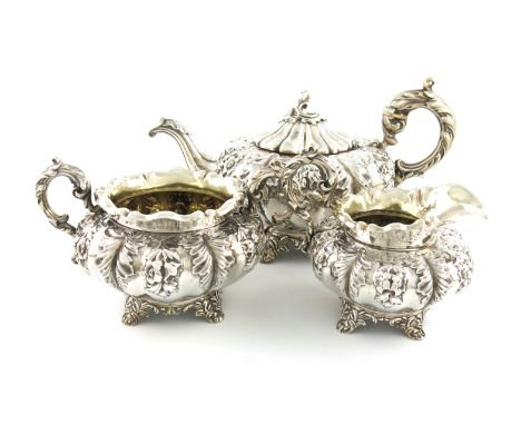 λA three-piece Victorian silver tea set, by Charles and George Fox, London 1850, lobed circular form, embossed foliate decora