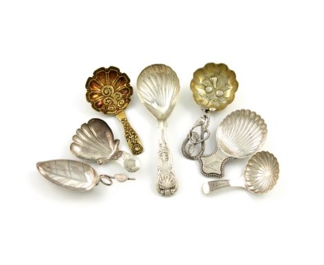 A collection of seven antique silver caddy spoons, comprising: a George IV silver-gilt one, with a foliate bowl, by Samuel Pe