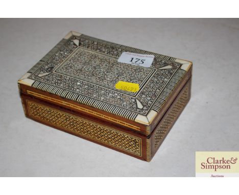 An Eastern mother of pearl inlaid trinket box and various contents to include coins, napkins rings etc.  