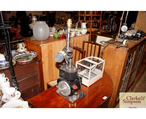 A novelty industrial style table lamp in the form of a small engine 