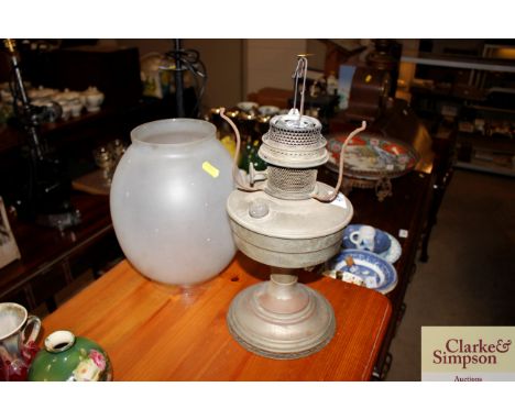 An oil lamp; and a frosted glass shade 