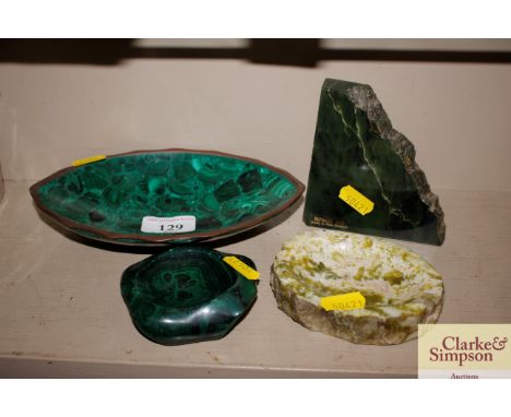 An oval malachite dish; a smaller similar; a Nephrite jade fragment; and a hardstone dish 