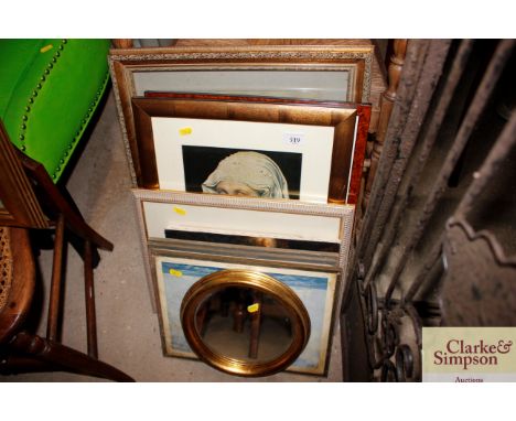 A collection of various decorative prints and a mirror 