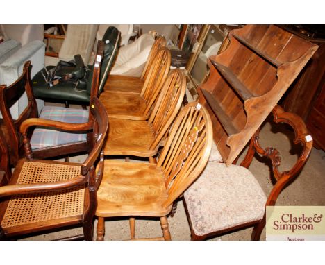 A set of four elm seated stick and wheel back dining chairs 