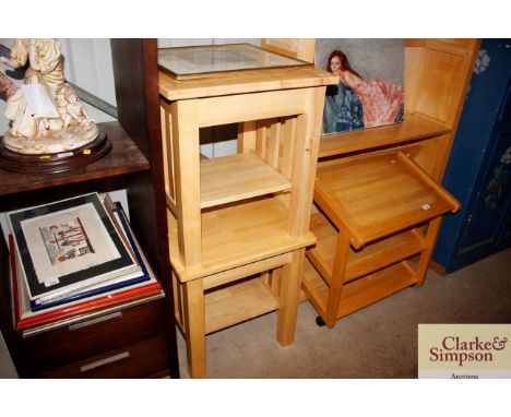 A pair of light wood two tier occasional tables 