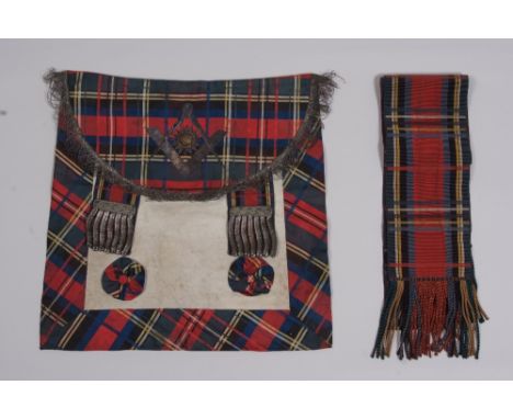 A SCOTTISH MASONIC APRON. An early C20th pigskin with a silk tartan and metalwork detail with masonic motif and tartan sash. 