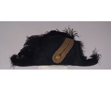 AMBASSADORS BICORN HAT WITH GOLD EPAULETS & FROCK COAT   A black bicorn hat with gold braid, button and  black plumage Labell