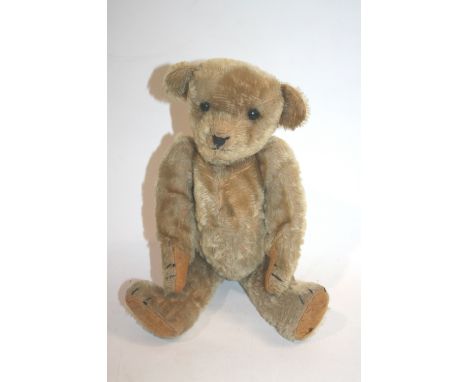 EARLY TEDDY BEAR a small Teddy Bear with black boot button eyes, hump back and elongated limbs. 12 1/2ins (32cms) high