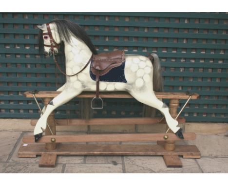 LARGE ANTIQUE ROCKING HORSE circa 1920 and made by Andrew Booth, with a saddle and bridle and on a large pitch pine base. 109