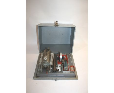 MODEL STATIONARY ENGINE - FITTED CASE a tin plate stationary engine, possibly German, with a chimney and pressure gauge. Fold