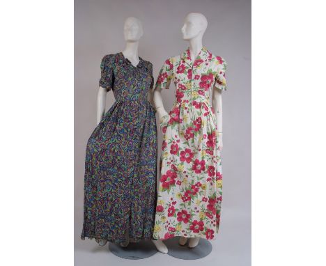 TWO 1940'S FLORAL PRINT DRESSES. A floral print cotton housecoat with front metal zip and attached belt.  waist 28". Geometri