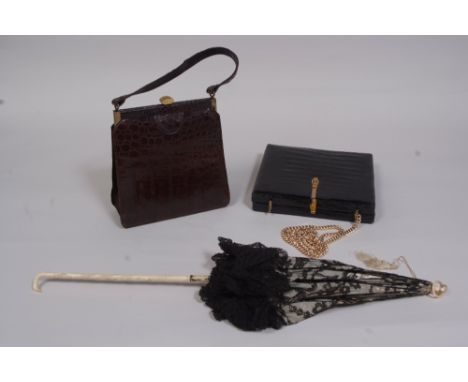 A MIXED LOT OF SCARVES, PARASOL,  CROCODILE HANDBAGS. A black lace parasol with white silk interior.  A pretty carved bone st