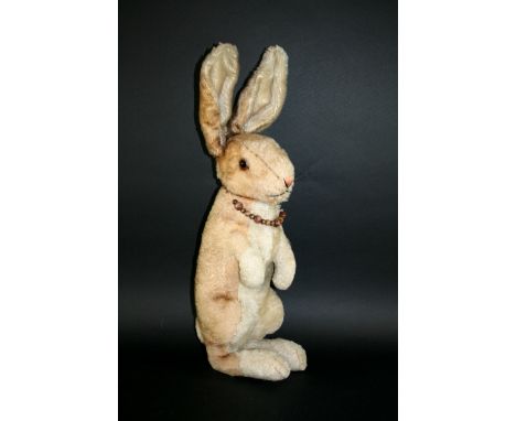 LARGE EARLY STEIFF RABBIT a large soft toy rabbit with glass eyes and swivel head, and upright ears. With a Steiff button in 